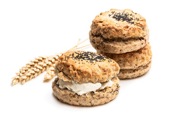 Wholemeal seeded scones stuffed with cream isolated on white