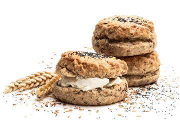 Wholemeal seeded scones stuffed with cream isolated on white