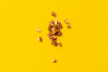 Obraz premium peeled walnut on yellow background isolated text design