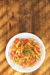 Spaghetti pasta with tomatoes and parsley on