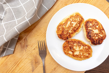 Russian syrniki or sirniki, homemade cottage cheese fritters or pancakes. breakfast with curd pankakes