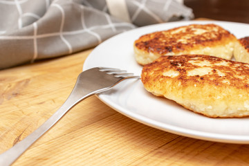 Russian syrniki or sirniki, homemade cottage cheese fritters or pancakes. breakfast with curd pankakes