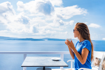 Tranquil morning serene woman relaxing drinking breakfast coffee enjoying ocean sea view on luxury hotel balcony, summer travel holidays. Home living.