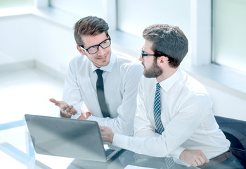 two business colleagues looking at the laptop screen