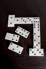 White Domino on a dark wooden table.