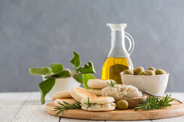 Crescentina modenese or tigelle ,  round breads from the Apennines, Modena area of Emilia-Romagna, Northern Italy, with cunza, a spread made from pork lard and flavoured with garlic and rosemary