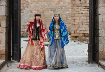 Fototapeta na wymiar Two beautiful oriental girls in national clothes, outdoors 