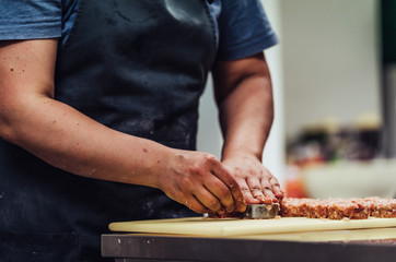 Female Chef Making Round Pork Cutlet for Some Burgers for Wedding Meal