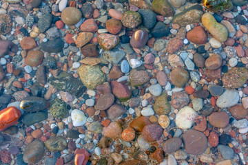 seabed from small pebbles through clear water, background