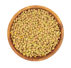 green lentil in wooden bowl isolated on white background. Top view