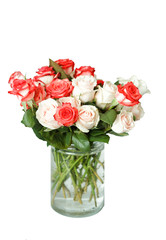 a bouquet of multi-colored roses  in a glass vase isolated white background