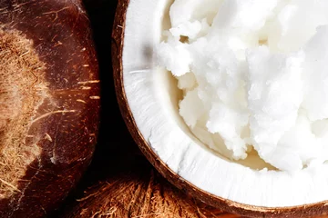 Vietnamese brown coconuts with coconut oil inside close up © amixstudio