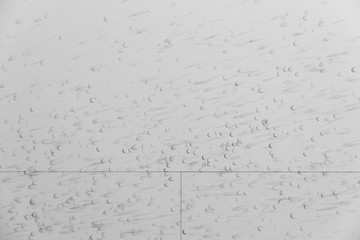 Detail of a white wall with many black traces left by a squash b