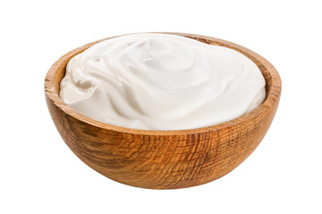 Sour cream in wooden bowl isolated on white background