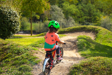 -small child is riding a bike in a bike parcours