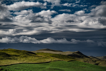 Iceland - entrance to Landmannalaugar - sunset view of clouds over summer hills