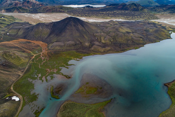Iceland - Landmannalaugar - Aerial view of glacier blue lake and river curve  in Volcano area Ljótipollur