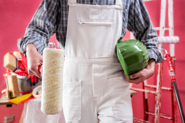 Professional house painter at work on the construction site. © francescomou