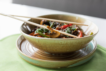 Buckwheat soba with veal, vegetables, mushrooms and asian food chopsticks