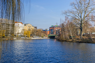 Spree river embankment Bundesratufer with the Lessing bridge and The House Lessing  in Berlin, Germany