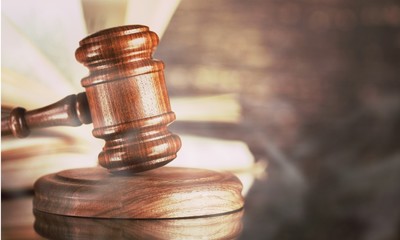 Books and wooden gavel on wooden table