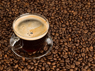 Cup of coffee on scattering of coffee beans