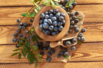 Fresh blueberries on rustic wooden background.Top view