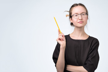 woman in eyeglasses in black dress giving advice having a good idea.