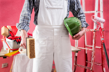 Professional house painter at work on the construction site. © francescomou