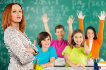 Female teacher with children at class on background