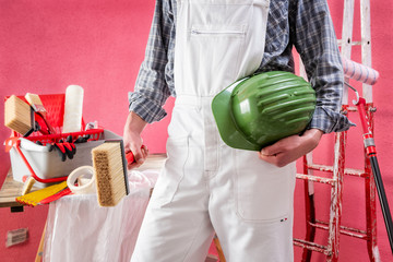 Professional house painter at work on the construction site. © francescomou
