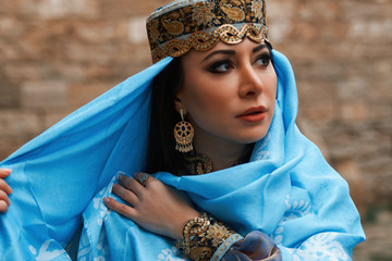 Beautiful middle eastern woman wearing traditional dress, posing outdoors