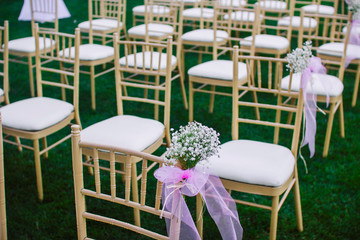 flowers in chairs wedding decoration