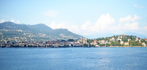 Naklejka na ściany i meble Panoramic summer view on the mundane and touristy city of Stresa and the mountains at Lago Maggiore in Piemonte, Italy