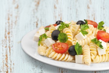 Pasta fusilli with bolognese tomato beef sauce on the kitchen table