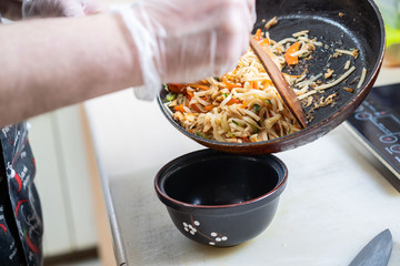 Japanese ramen soup with chicken, egg, chives and sprout on dark wooden background.