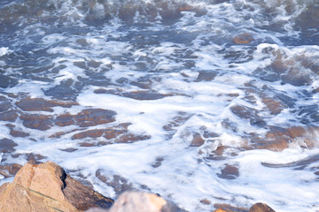 Hendaye France the foam of the waves arriving on the stones