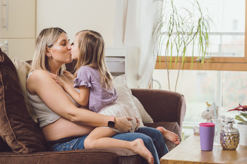 Mother mom daughter girl pregnant living room happiness