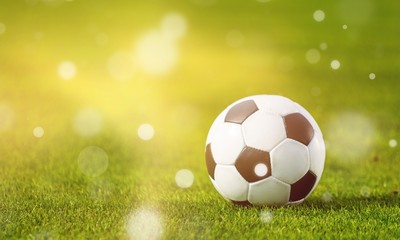 Close view of green football field with soccer ball