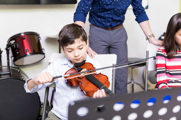 Boy Practicing To Be A Good Violin Player