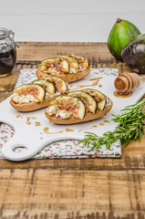 Fototapeta na wymiar Swedish toasts with figs, cheese, rosemary, honey and walnuts