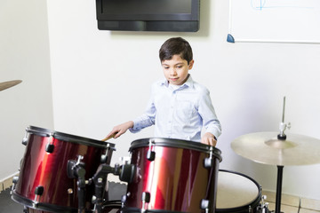 Boy Playing Percussion Instrument In Music Session