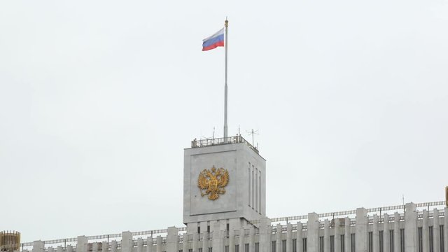 close-up view of symbols of government of Russia, flag and crest on top of building