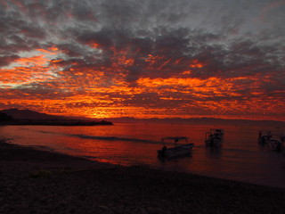 sunrise on the beach with boats