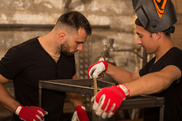 Two strong male worker, measuring by measuring tape metal construction.