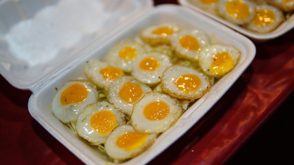 Fried Quail's egg on styrofoam plate