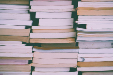 Fototapeta premium Stack of many old books background on shelf in book store or library room. Knowledge learning, education, bachelor degree in university or back to school concept.