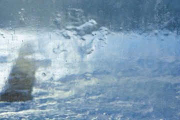 Naklejka na ściany i meble The texture of the ice. The frozen water.Winter background 