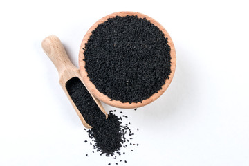 nigella seeds  in wooden bowl and scoop isolated on white background