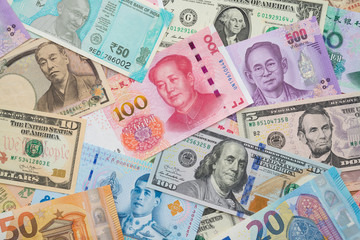 Fototapeta na wymiar Flat lay or top view of world international banknotes vary countries background. US Dollar, Chinese yuan, Japanese yen, Euro, Indian rupee, Thai baht. Concept of Forex or global financial economic.